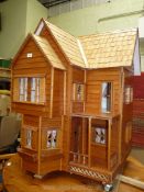 A large bamboo hand made Dolls House, from Malaysia Orphanage charity, on castors,