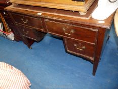A dark wood dressing table with two long and two short drawers,