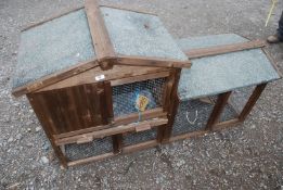 A rabbit hutch with litter tray 34'' high, with run.