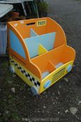 A child's wooden taxi storage unit on wheels.