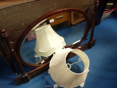A large oval swing mirror for a dressing table with frame 45 1/2" W plus a cream fabric lamp shade.