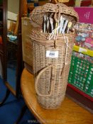 A wicker knitting needle holder and contents