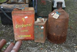 Three vintage fuel cans including one with brass filler top and one with bottle neck.