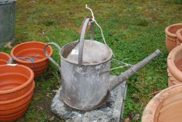 A 1 1/2 gallon galvanised watering can.