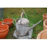 A 1 1/2 gallon galvanised watering can.