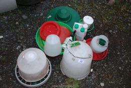 A quantity of plastic poultry feeders, water and topical treatments.