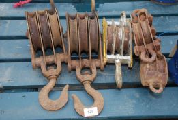 Five metal rope pulleys, various sizes.