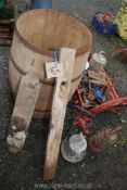 A wooden water butt with tools, plastic tray of tools and saddle racks.