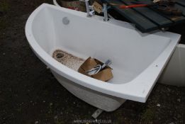 A Cersanit corner bath with taps and shower head.