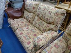 A two seater sofa and matching armchair in Aztec print , both reclining.