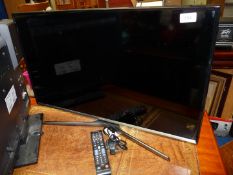 A Samsung flat screen TV with remote, 31'' screen.