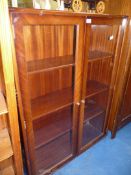 A dark-wood bookcase with glazed doors, 36" W x 48" H.