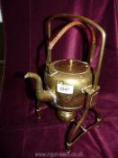 A brass kettle and stand (spirit kettle with wicker handle).