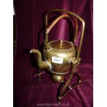 A brass kettle and stand (spirit kettle with wicker handle).