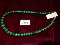 A graduated Malachite necklace, 20'' long.