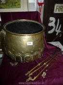 A brass coal scuttle and three fire irons including tongs and two pokers,