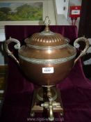 A Copper and brass Samovar, 19" tall with scrolled fish shape handles, (tap handle missing).