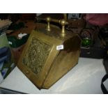 A brass Coal Scuttle with sunflower detail to the front, with shovel, a/f.