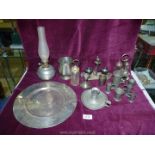 A quantity of plated items including a set of four centilitres measures, cruet set, chamberstick,