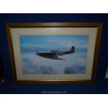 A framed and mounted Print of a Spitfire, no visible signature, 30'' x 21 1/2''.