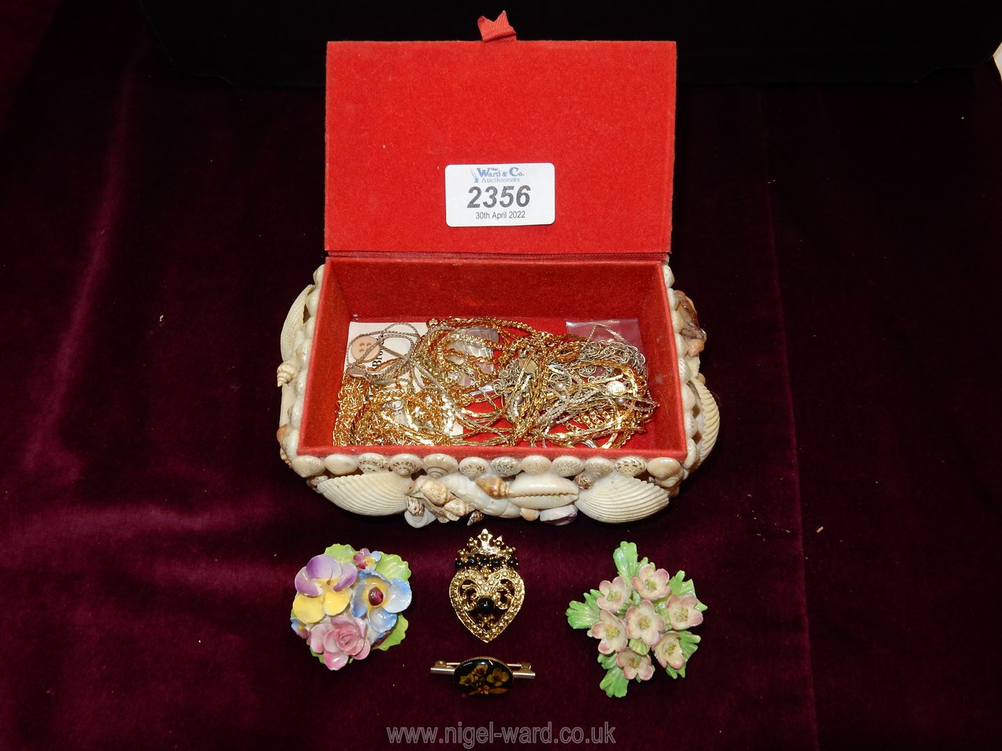 A shell encrusted jewellery box and contents of chains, floral brooches, bracelets etc.
