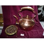 A Copper kettle (a/f) and a brass trivet.