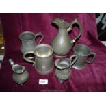 A quantity of Pewter jugs and tankards.