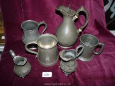 A quantity of Pewter jugs and tankards.