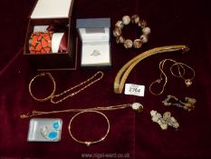 A box of mixed costume jewellery including bracelets, pendants etc.