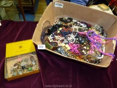 A box of costume jewellery and a tin of brass buttons including Australian Military Forces uniform