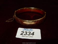 A rolled gold Bangle with safety chain, by L & Co.