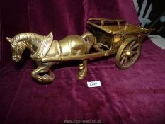 A large and heavy brass horse and cart.