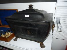 A metal log box with lid having lion handles,