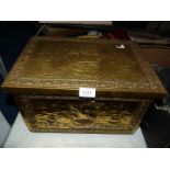 A brass slipper box with nautical scenes.