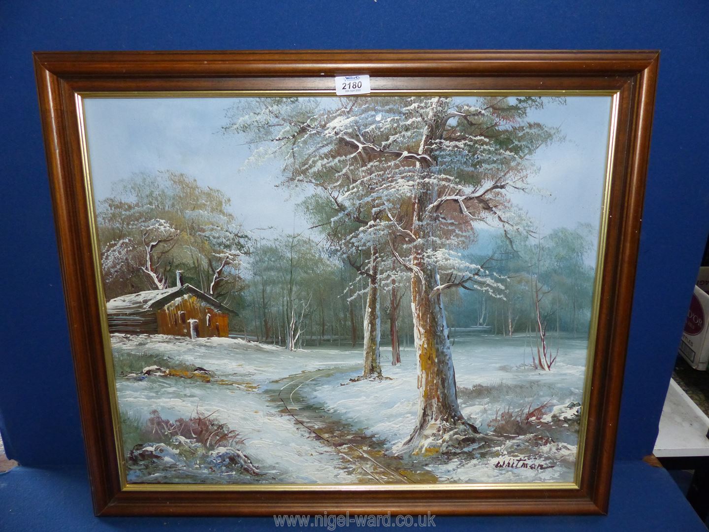 An Oil on canvas of a snowy woodland scene by Whitman