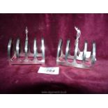 A pair of silver four division toast racks of arched form having centre carrying handle,