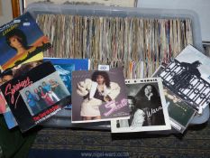 A large quantity of 7" vinyl records to include Whitesnake, Vanhalen, Tears for Fears,