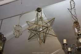 A large glass star shaped light fitting, (one section of glass cracked).