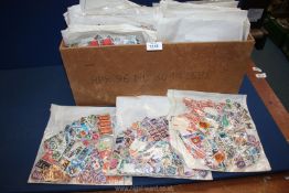 A large quantity of loose used Foreign and English stamps, including USA, Spain,