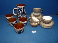 A quantity of Denby cups and saucers and Gluvein set of jug and four cups.