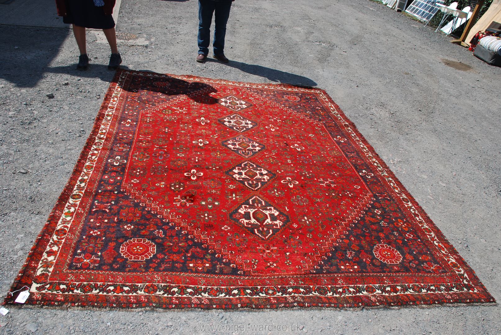 A large burgundy, navy and cream bordered, patterned and fringed Carpet, made in Iran, 120'' x 90''. - Image 2 of 2