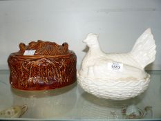 A white Portmeirion Hen on Nest and brown Portmeirion pate dish.