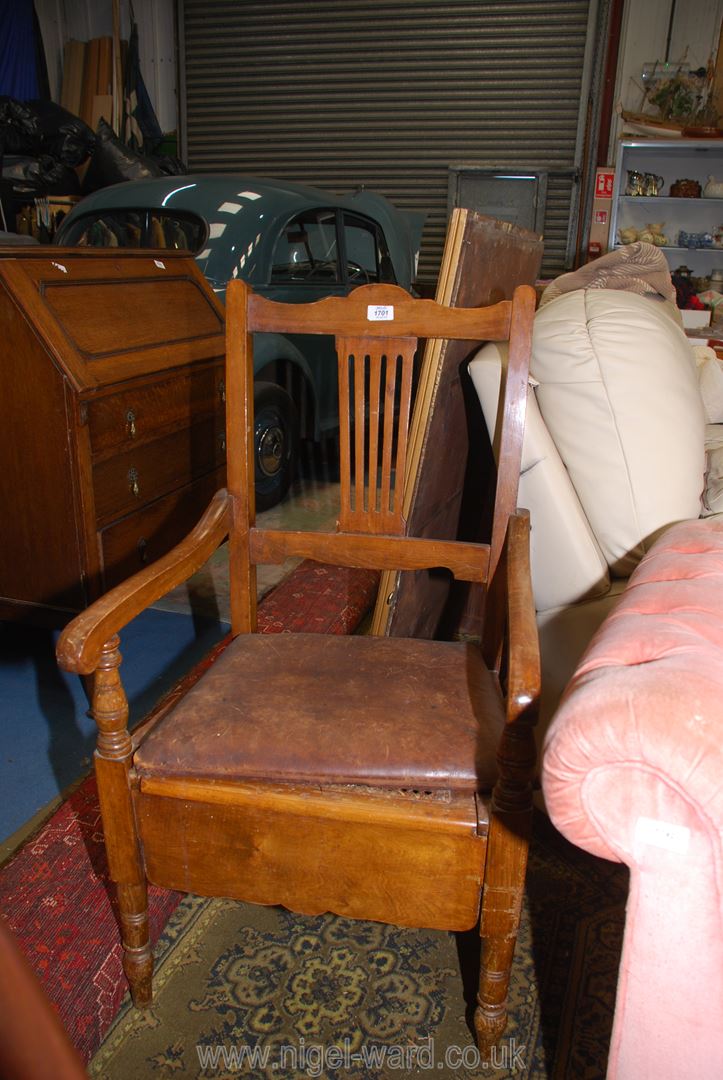 A satinwood framed open armed Commode Armchair having a caned seat,