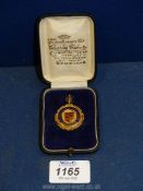 A 9ct gold and enamel 'Abergavenny League Champions 1923-24' Medal in blue and red to the crest and