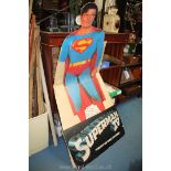 A large floor standing cardboard cut-out figure of Superman,