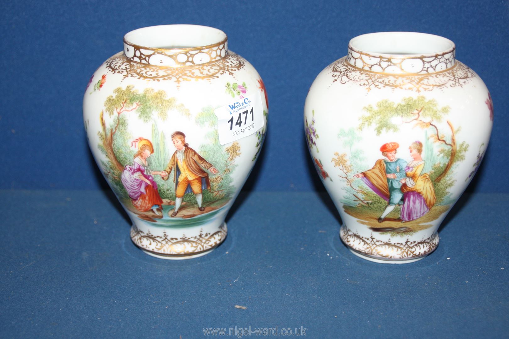 Two similar looking Dresden china vases gilded and hand painted with Victorian scenes 5 1/2" tall.