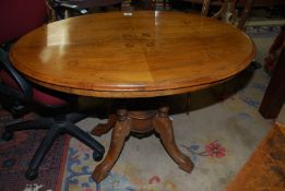 A Walnut snap-top oval Centre Table,