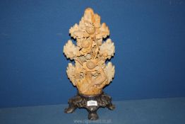 A large brown Soapstone carving of bird and floral bush on plinth, 16" tall.