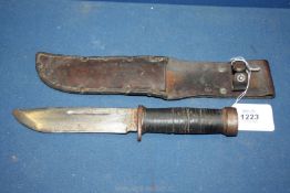A Cattaraugus Commando knife in leather scabbard, 10 1/2'' long.