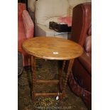 An oval light Oak occasional Table standing on twist legs united by a perimeter stretcher,